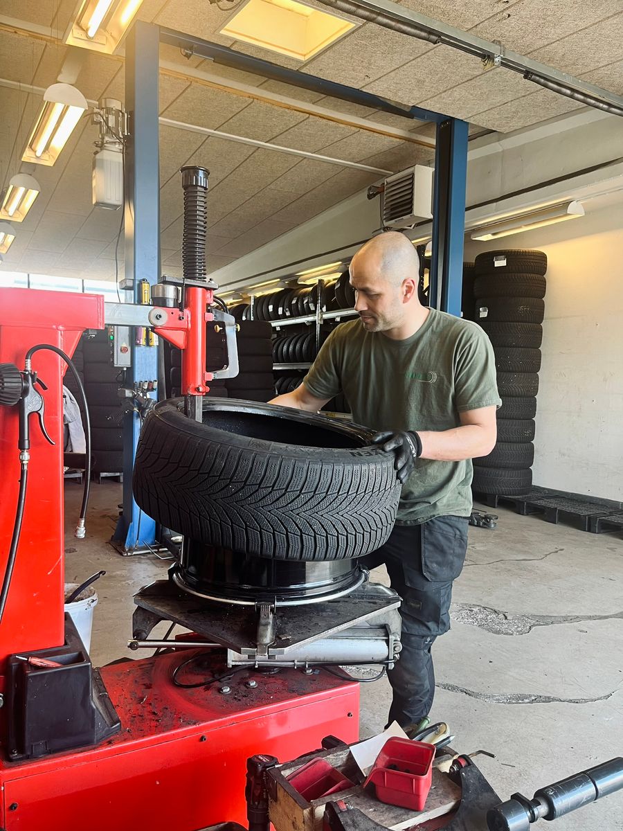 Fitting a winter tyre on a rim with a tyre machine at KT Dækservice in Viby J, Aarhus